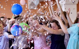 kids-having-fun-at-a-childrens-party-in-the-rain-of-shiny-confetti-celebrate-togetherness-boys-pupils_t20_QzZn9j